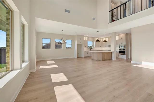 a view of a room with wooden floor and staircase
