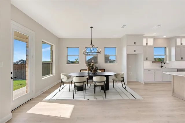 a view of a kitchen with refrigerator and window