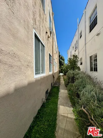 a pathway of a house with a yard