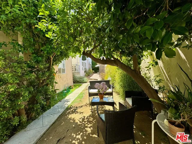 a view of a house with large trees