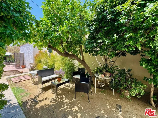a wooden bench sitting in the middle of a yard