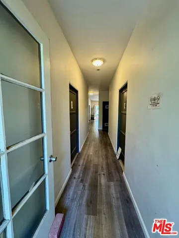 a view of hallway with wooden floor