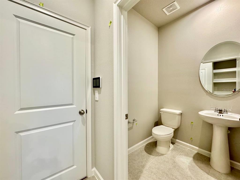 3247 Feather Hvn Place Brandon, FL 33511 - Photo 13 of 34 a bathroom with a toilet sink a shower and a mirror