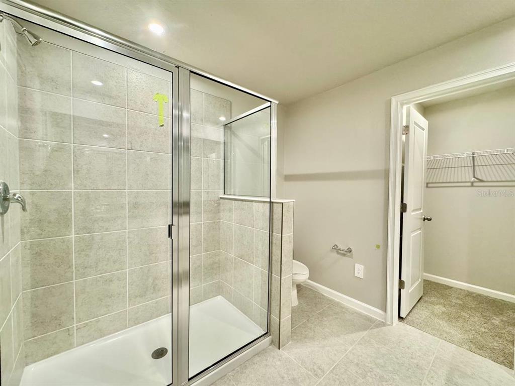 3247 Feather Hvn Place Brandon, FL 33511 - Photo 28 of 34 a bathroom with a glass shower door