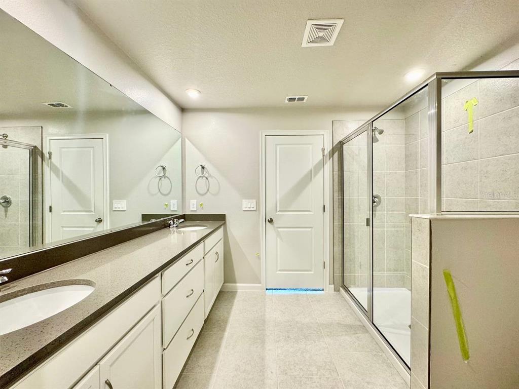 3247 Feather Hvn Place Brandon, FL 33511 - Photo 29 of 34 a spacious bathroom with a granite countertop sink a mirror and a shower