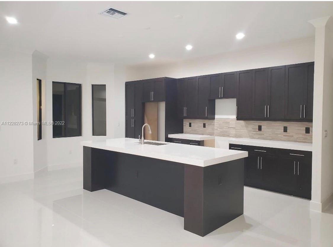 18830 Southwest 354th Street Homestead, FL 33034 - Photo 5 of 14 a kitchen with stainless steel appliances a sink stove and cabinets
