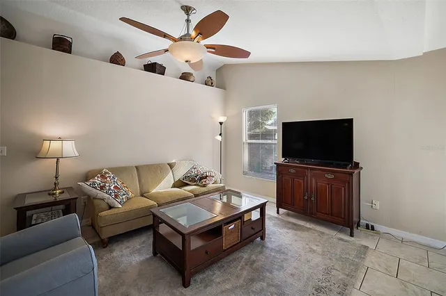 a living room with furniture and chandelier