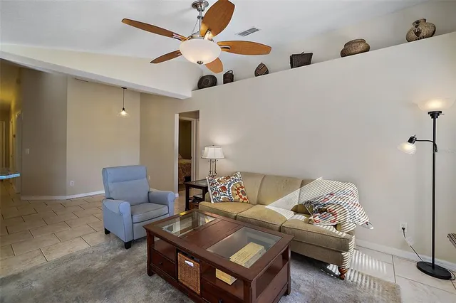 a dining room with granite countertop furniture a chandelier and a window