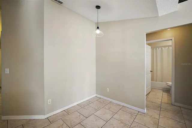 a kitchen with granite countertop a refrigerator a stove and cabinets