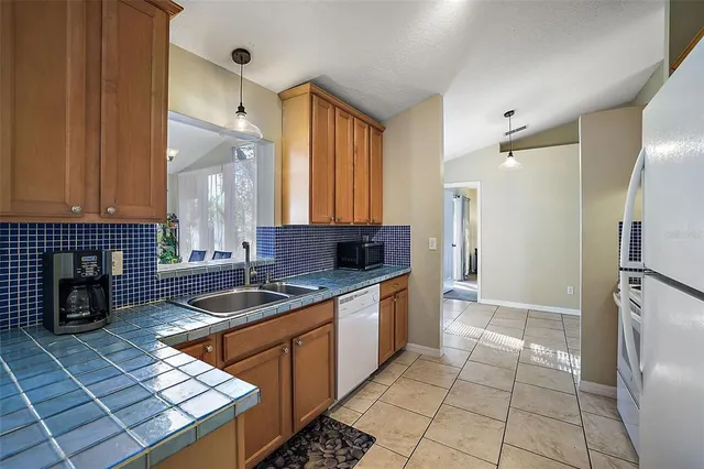 a kitchen with stainless steel appliances a stove sink and cabinets