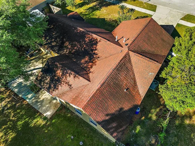 a front view of house with yard and trees around