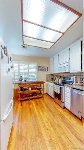 a living room filled with furniture and a flat screen tv