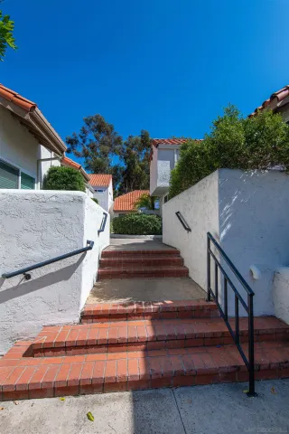 a view of street along with house and trees