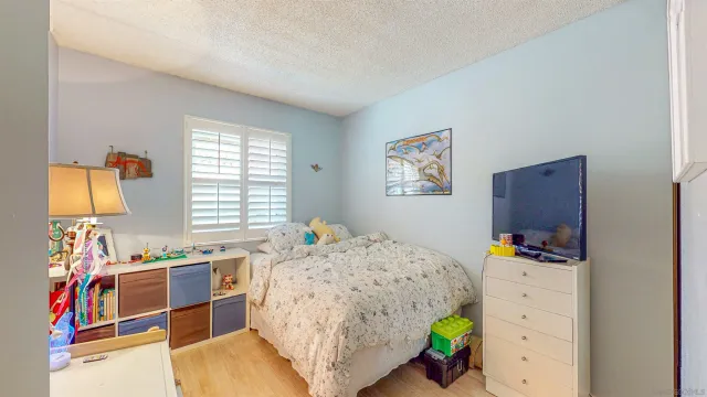 a view of a kitchen with granite countertop a sink and a window