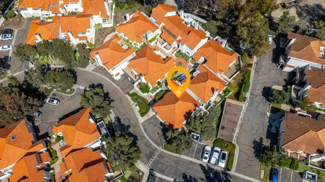 an aerial view of residential houses with outdoor space and covered by wooden tree