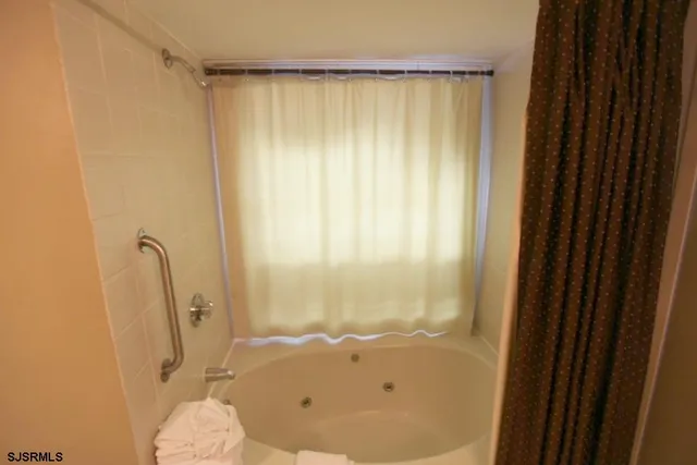 a bathroom with a tub and a shower