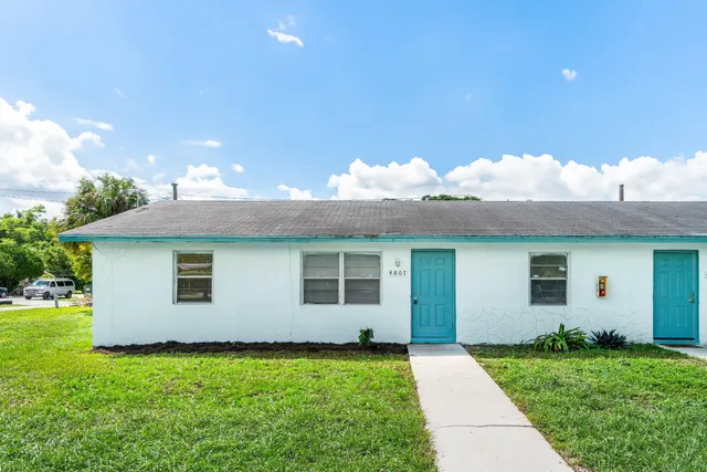 a view of a house with a yard and front a house