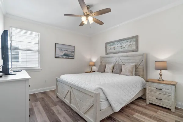 a bedroom with a bed and a chandelier
