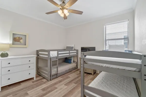 a bedroom with a bed and a chandelier