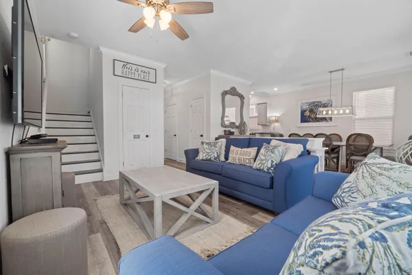 a living room with furniture and a chandelier
