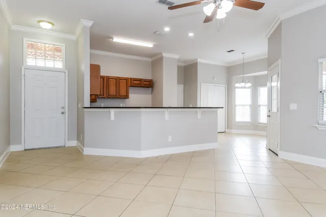 a view of a hallway with wooden floor and chandelier