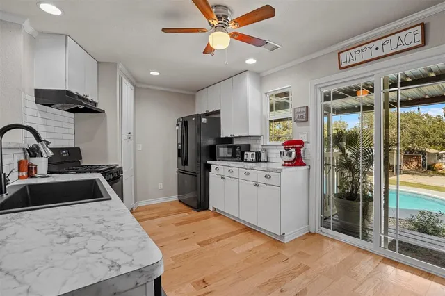 a kitchen with stainless steel appliances granite countertop a stove and a sink