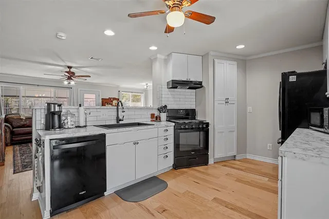 a spacious bedroom with a bed and a flat screen tv