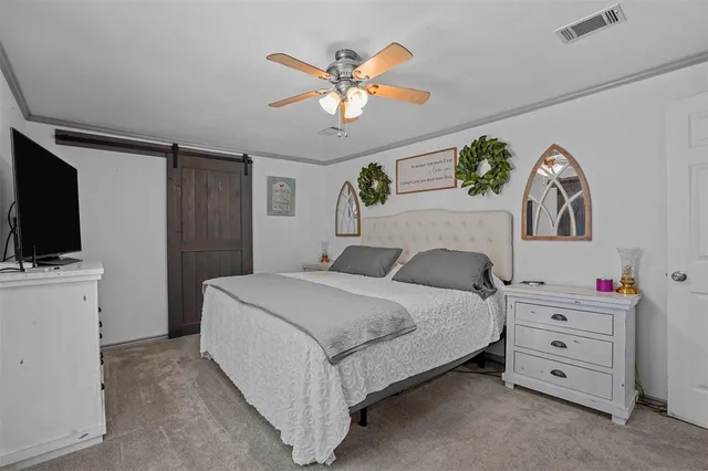 a bedroom with a bed and a dresser