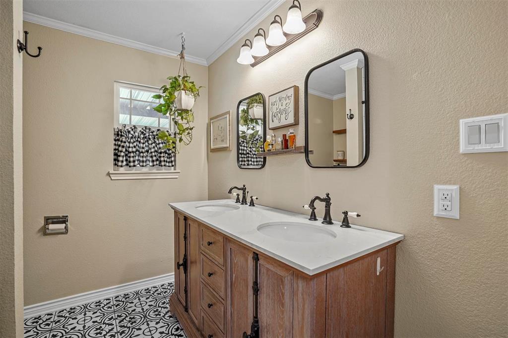 7130 Briar Road Azle, TX 76020 - Photo 16 of 37 a bathroom with a sink and a mirror