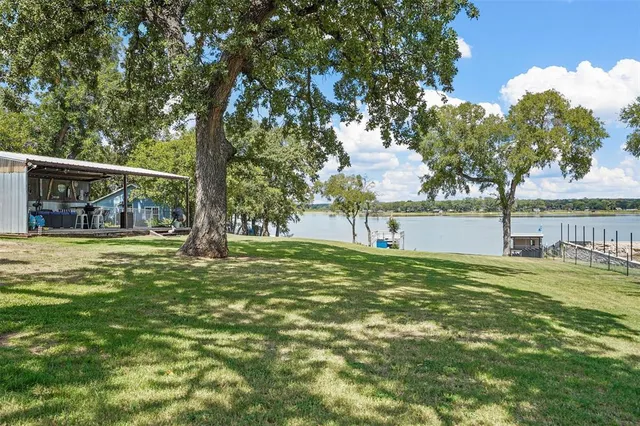 a view of a house with a yard and sitting area
