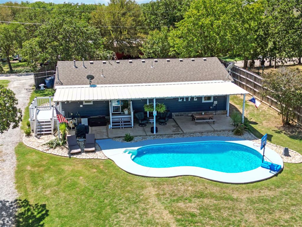 7130 Briar Road Azle, TX 76020 - Photo 35 of 37 a view of a swimming pool with chairs