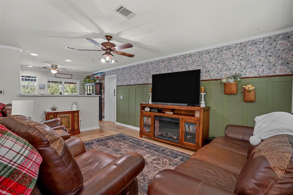 7130 Briar Road Azle, TX 76020 - Photo 8 of 37 a living room with furniture and a flat screen tv