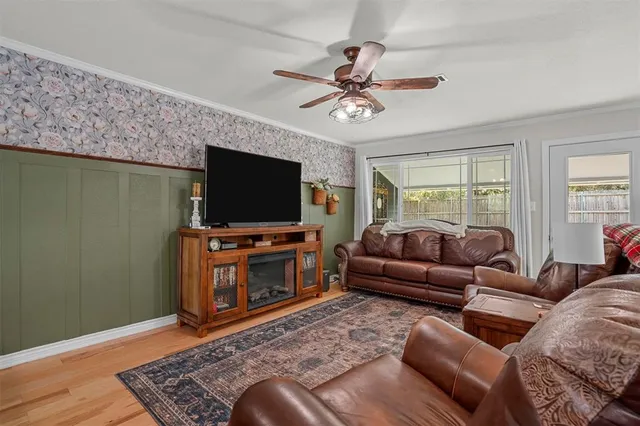 a living room with furniture ceiling fan and a rug