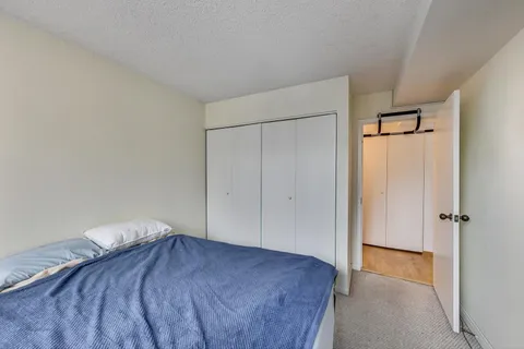 a bedroom with a bed and a shower