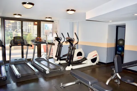 a kitchen with a refrigerator and a wooden floor