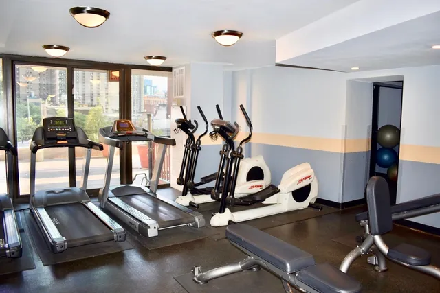 a kitchen with a refrigerator and a wooden floor