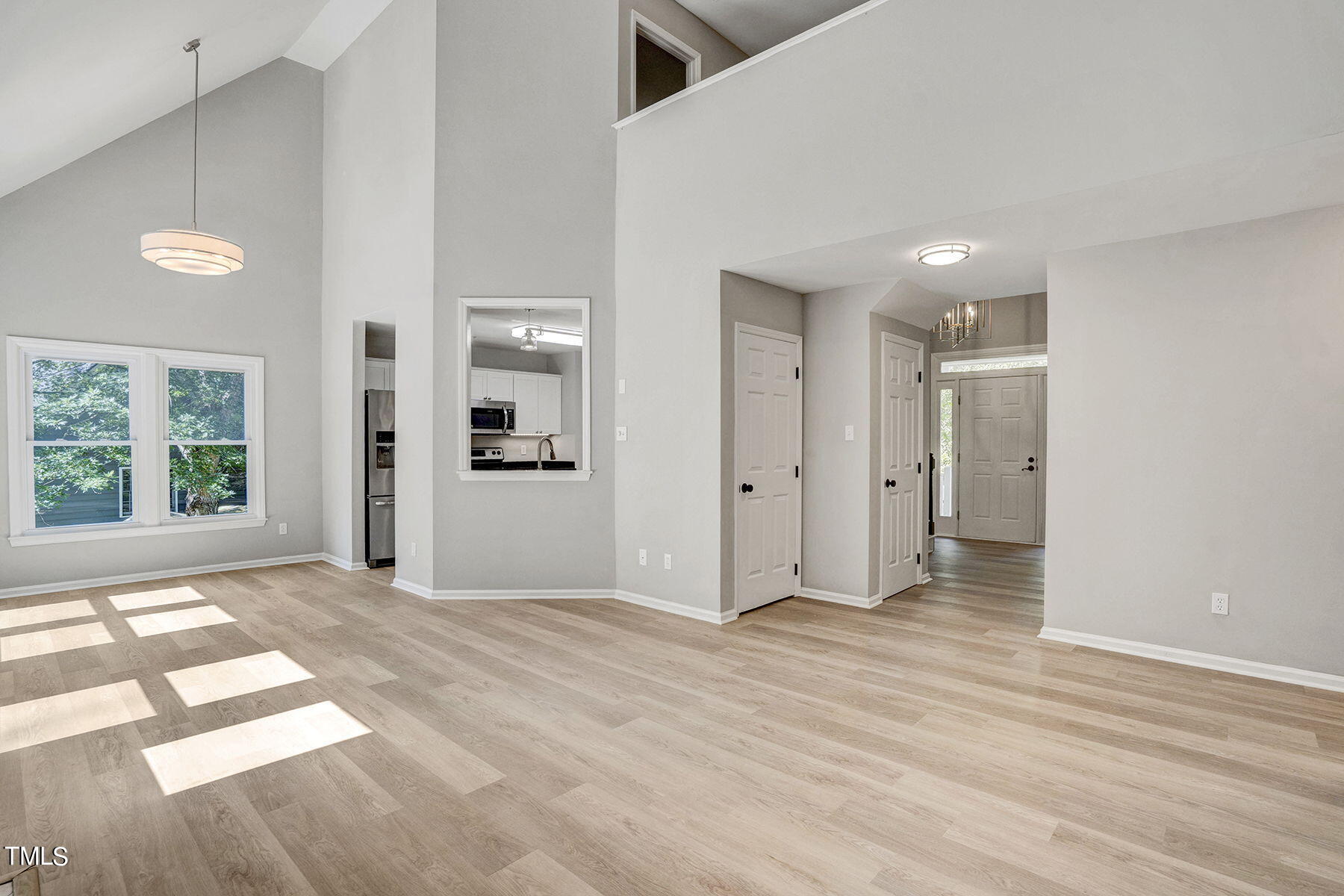 1248 Hillingdon Way Raleigh, NC 27614 - Photo 13 of 32 a view of a big room with wooden floor and windows