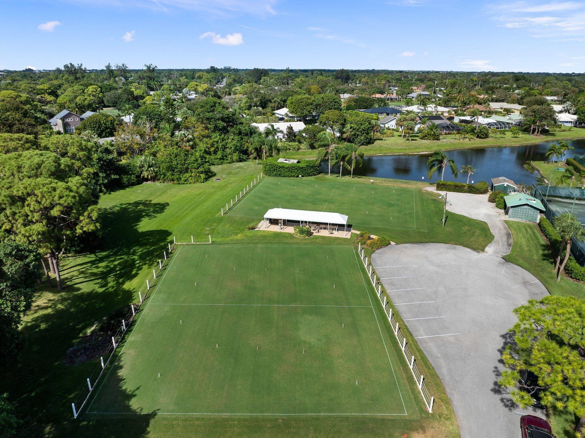 3374 Southeast Fairway East Stuart, FL 34997 - Photo 62 of 65 an aerial view of a golf course with parking space