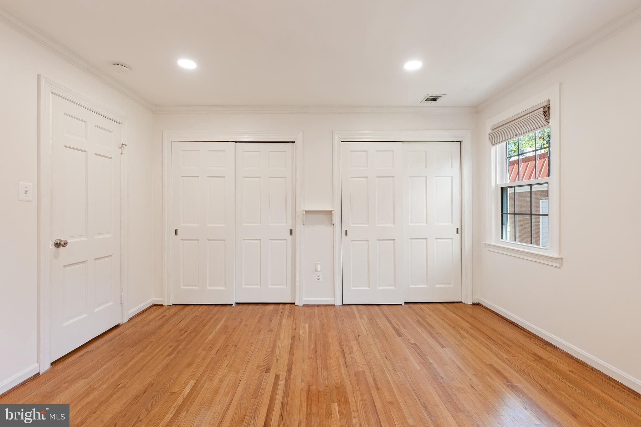 706 6th Street Southwest Washington, DC 20024 - Photo 15 of 39 an empty room with wooden floor and windows