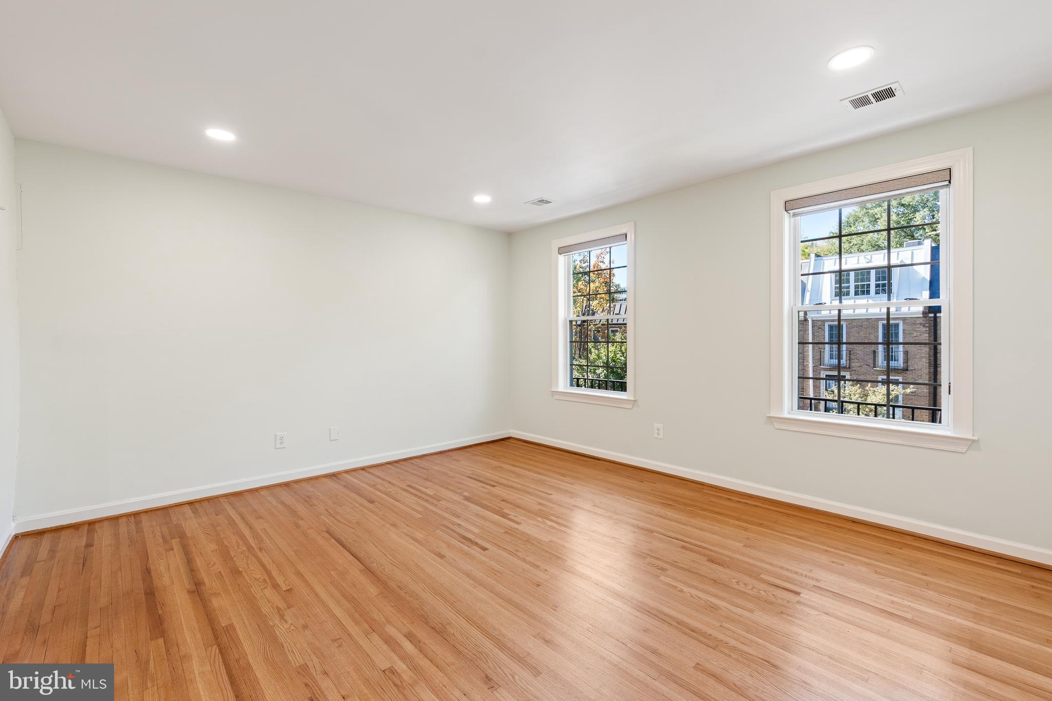 706 6th Street Southwest Washington, DC 20024 - Photo 22 of 39 an empty room with wooden floor and windows