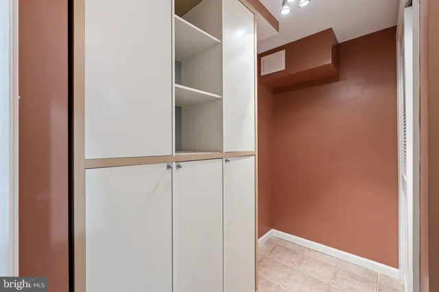 a view of staircase with lots of frames on wall and a window