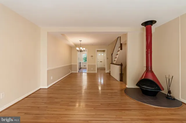 a view of empty room with wooden floor and stove