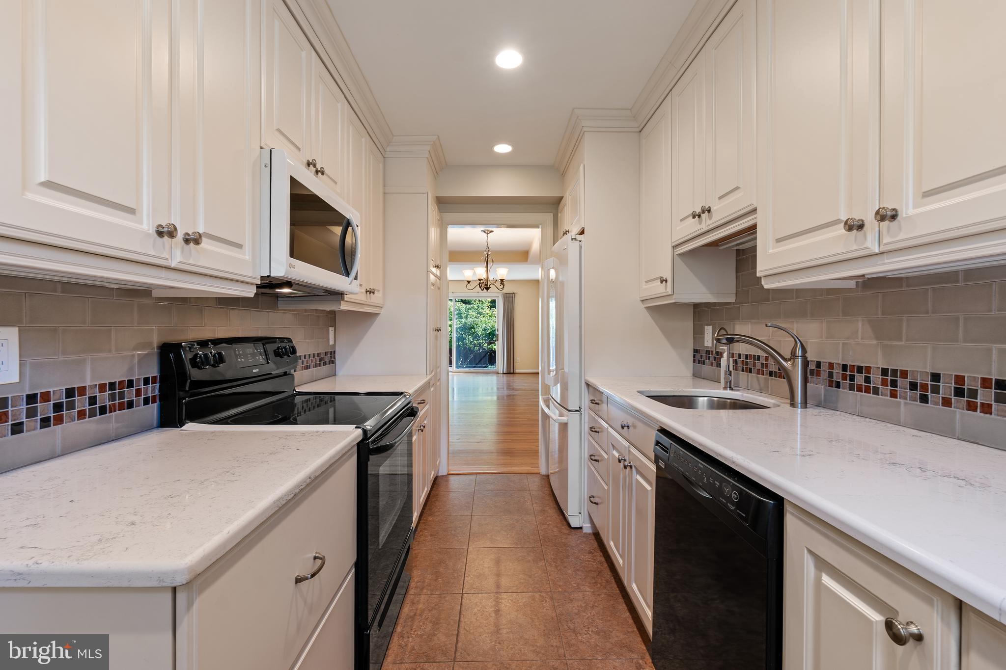 706 6th Street Southwest Washington, DC 20024 - Photo 9 of 39 a kitchen with stainless steel appliances granite countertop a sink a stove and a refrigerator