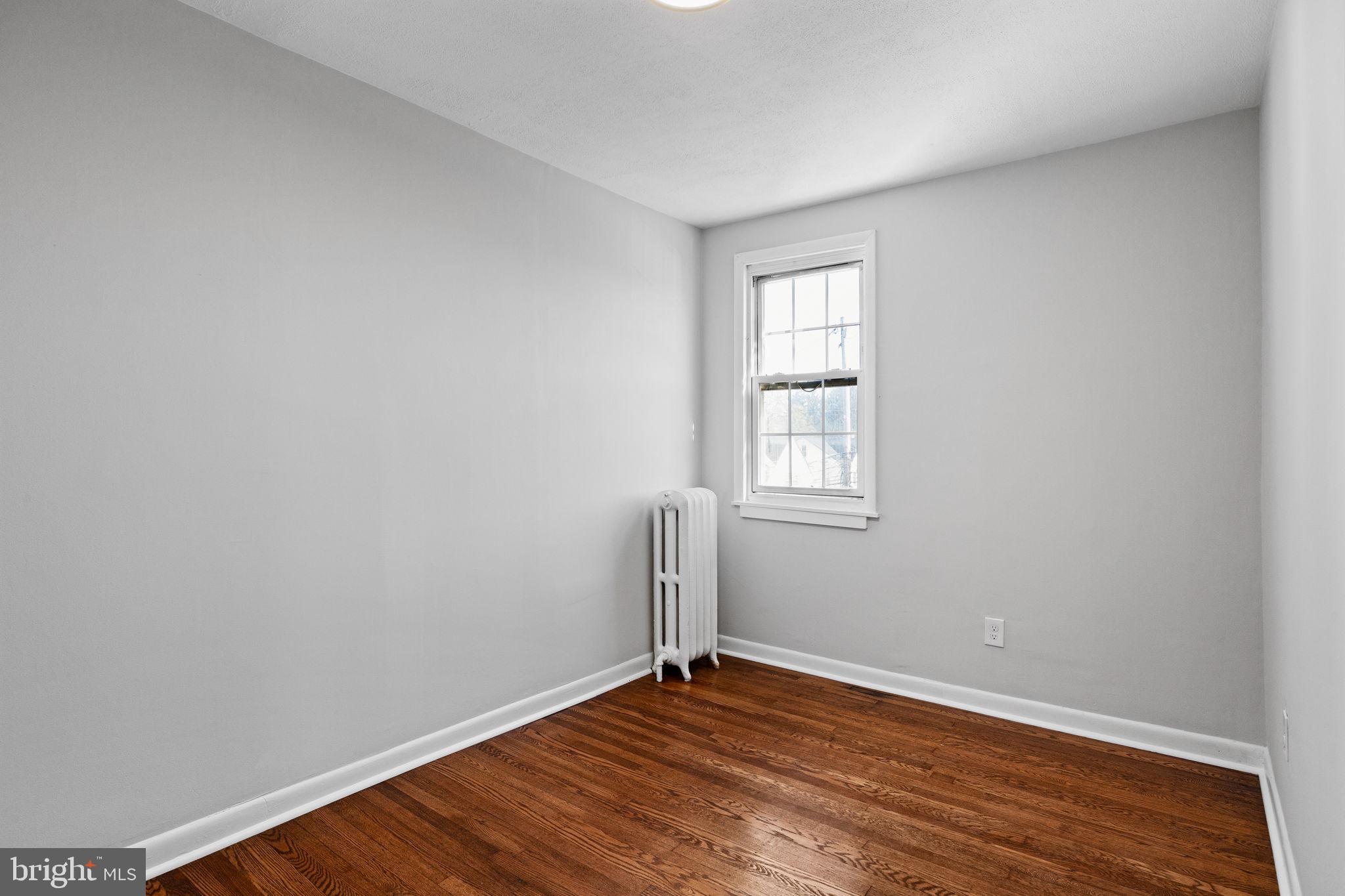 171 North Carol Boulevard Upper Darby, PA 19082 - Photo 17 of 32 an empty room with wooden floor and windows