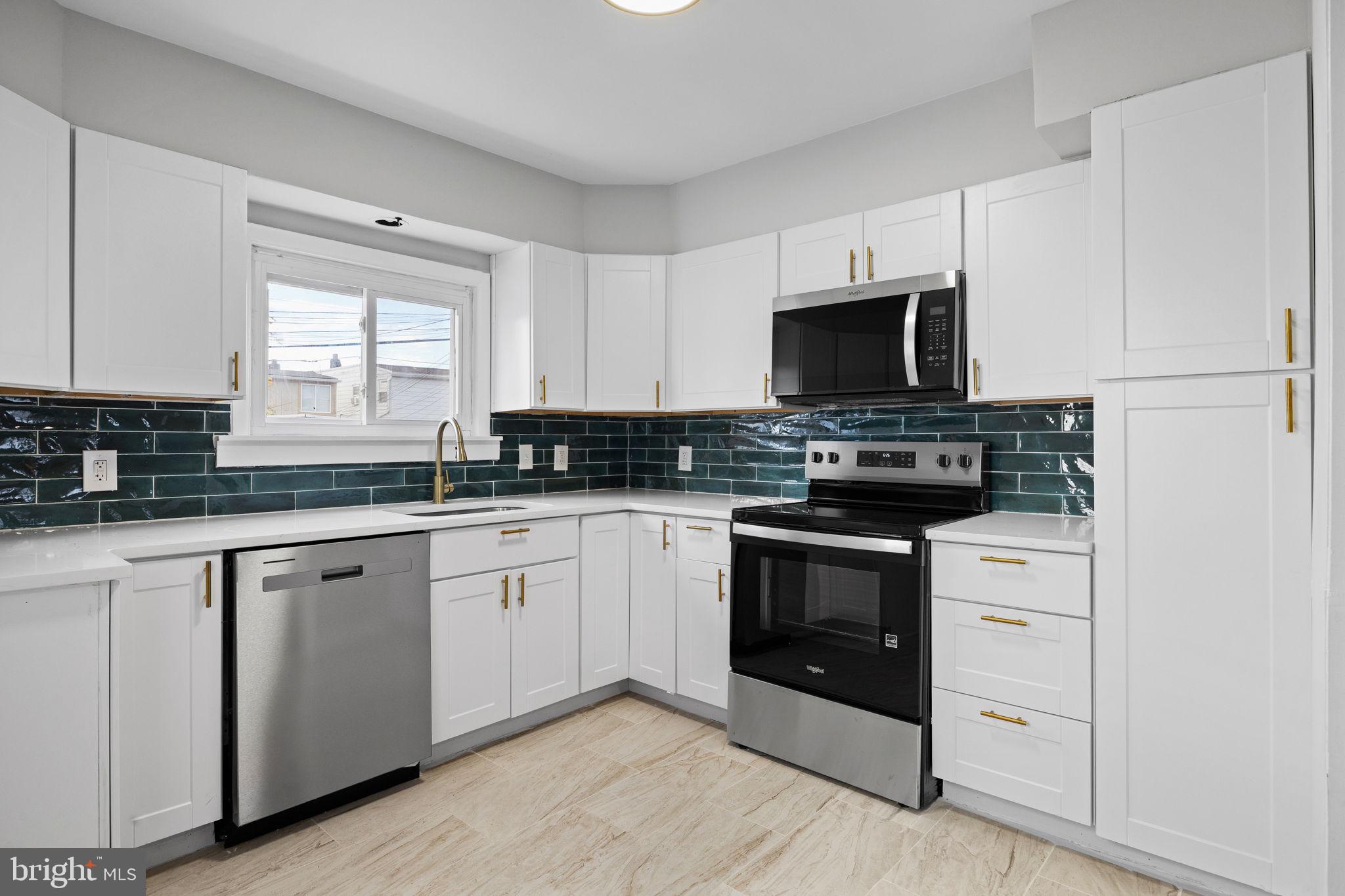 171 North Carol Boulevard Upper Darby, PA 19082 - Photo 7 of 32 a kitchen with white cabinets and appliances