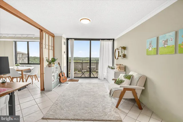 a living room with furniture and large windows