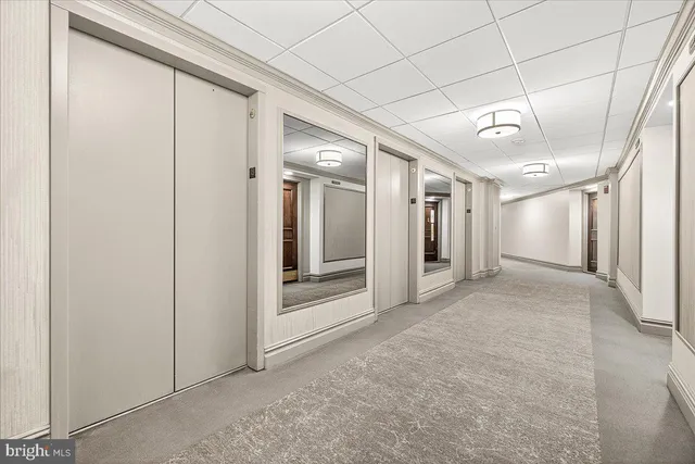a view of a hallway with wooden shelves