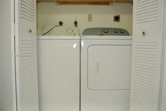 a view of an empty room with chandelier