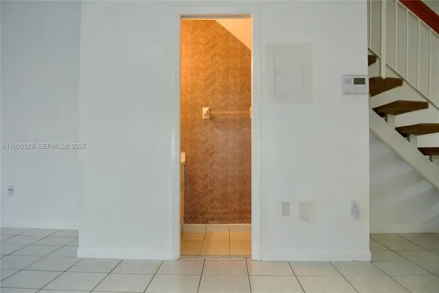 a white toilet sitting next to a shower curtain