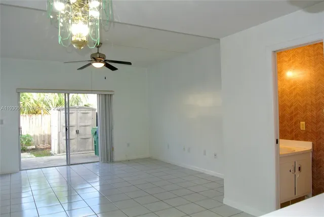 an empty room with sliding door and glass door